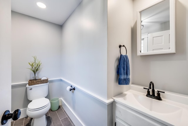 bathroom with recessed lighting, toilet, vanity, and tile patterned flooring