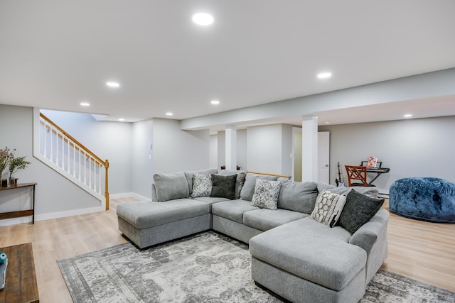 living area with stairway, recessed lighting, light wood-type flooring, and baseboards