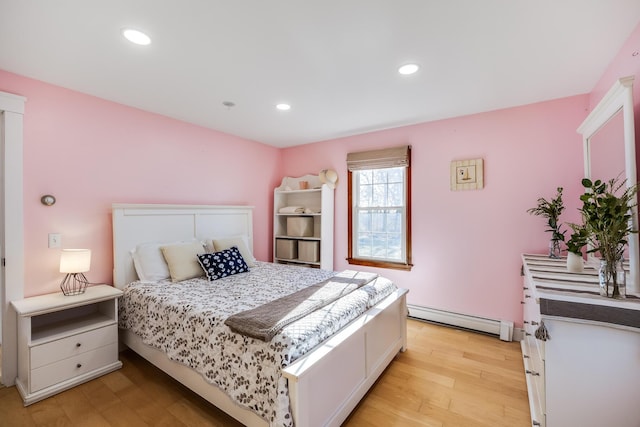 bedroom with recessed lighting, light wood-style flooring, and a baseboard radiator