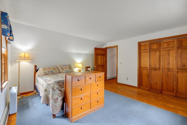 32 Purmackene Ln, Harwich Port, MA 02646 - bedroom featuring light wood-type flooring, baseboard heating, vaulted ceiling, and a closet