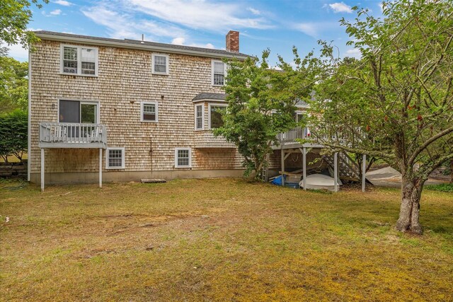 32 Purmackene Ln, Harwich Port, MA 02646 - rear view of house with a chimney, a yard, and a wooden deck