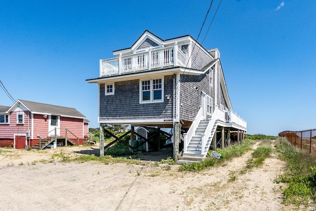 6 Baker Way, West Dennis, MA 02670 - coastal home with a balcony, driveway, and stairway