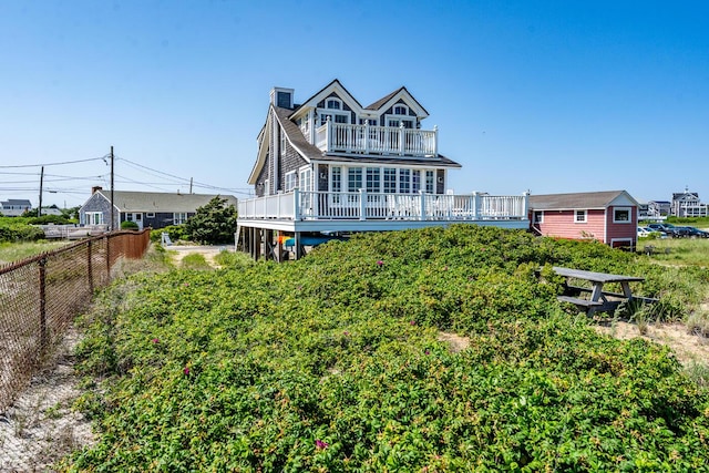 6 Baker Way, West Dennis, MA 02670 - back of property featuring a chimney, a deck, and a balcony