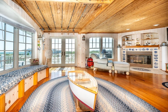 6 Baker Way, West Dennis, MA 02670 - living room with wood ceiling, hardwood / wood-style flooring, french doors, healthy amount of natural light, and wood walls