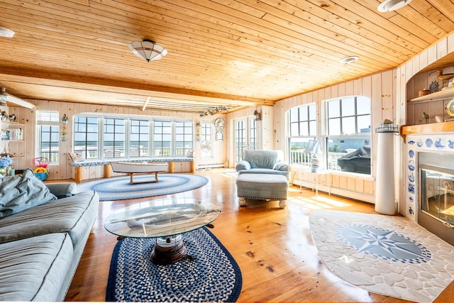 6 Baker Way, West Dennis, MA 02670 - living room with wooden ceiling, a baseboard radiator, wood walls, wood finished floors, and healthy amount of natural light