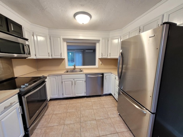 kitchen with light countertops, appliances with stainless steel finishes, and a sink