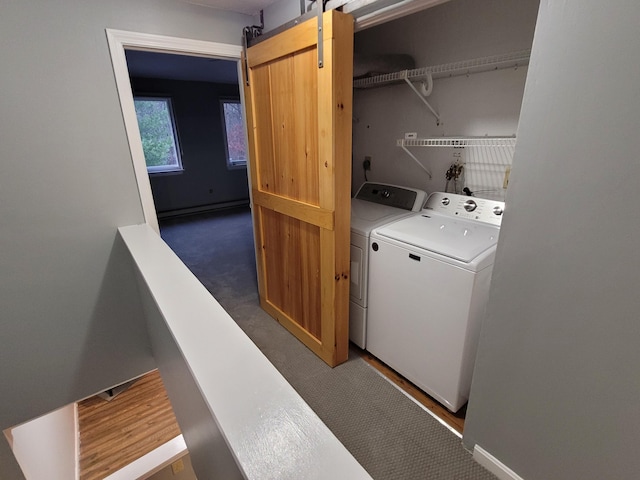 washroom featuring laundry area, carpet floors, a barn door, a baseboard radiator, and independent washer and dryer