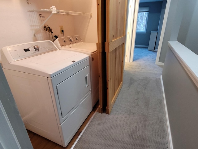 washroom featuring washer and dryer, laundry area, and carpet flooring