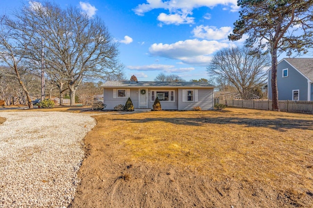 single story home featuring fence and a front lawn