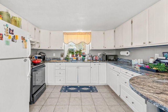 kitchen featuring light tile patterned floors, white cabinets, under cabinet range hood, black appliances, and a sink