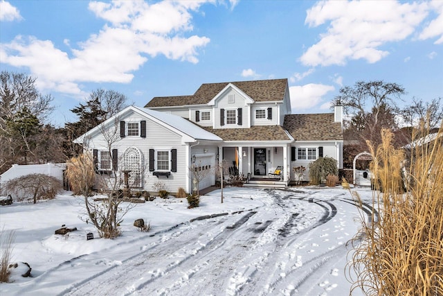 traditional-style house with an attached garage and covered porch