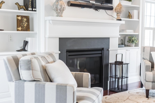 780 Craigville Beach Rd Unit B1, Centerville, MA 02632 - living area with a glass covered fireplace, plenty of natural light, wood finished floors, and built in shelves