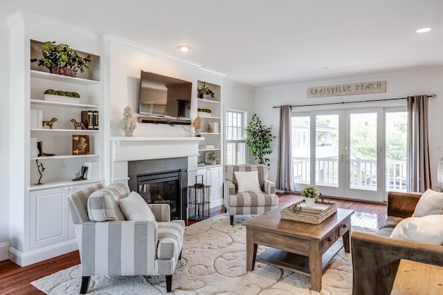 780 Craigville Beach Rd Unit B1, Centerville, MA 02632 - living area with wood finished floors, ornamental molding, french doors, a glass covered fireplace, and built in shelves