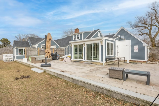 rear view of house with outdoor lounge area and a patio