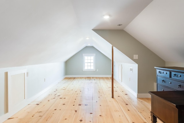 bonus room with wood-type flooring and lofted ceiling