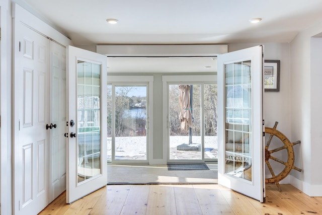 entryway featuring french doors and light hardwood / wood-style flooring