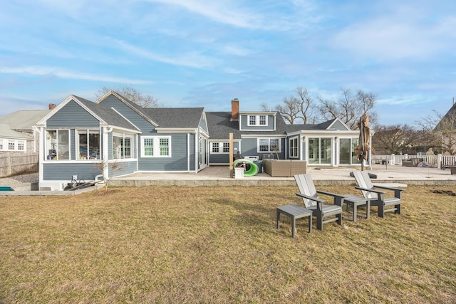 rear view of house with a patio area and a lawn