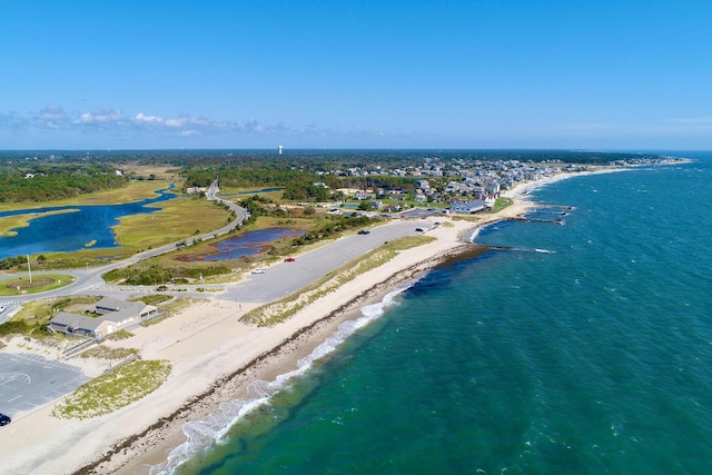 birds eye view of property featuring a beach view and a water view