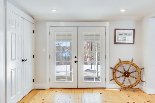 entryway featuring light wood-type flooring and french doors