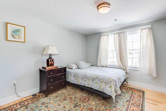 bedroom featuring hardwood / wood-style flooring and multiple windows