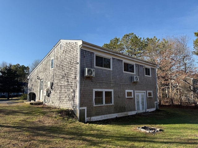 back of house featuring french doors, ac unit, and a lawn