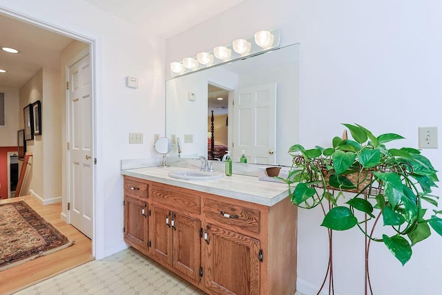 bathroom featuring tile patterned floors, recessed lighting, baseboards, and vanity