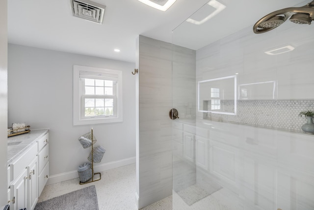 bathroom featuring walk in shower, decorative backsplash, baseboards, recessed lighting, and vanity