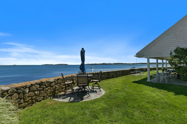 view of yard with a water view and a patio area