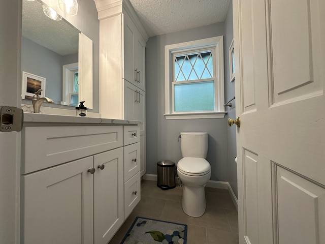 14 Daisy Ln, South Yarmouth, MA 02664 - bathroom with a textured ceiling, vanity, toilet, baseboards, and tile patterned floors