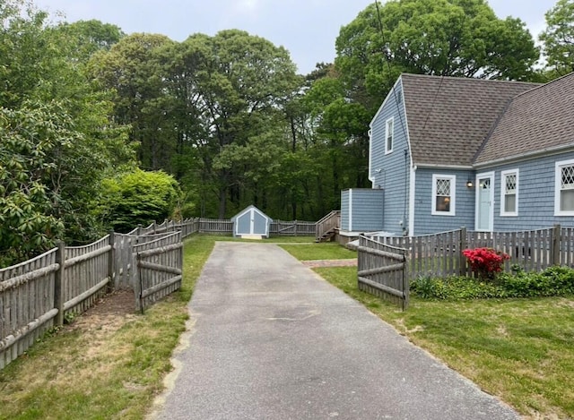 14 Daisy Ln, South Yarmouth, MA 02664 - view of side of home with roof with shingles and asphalt driveway