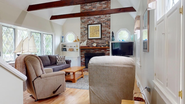 14 Daisy Ln, South Yarmouth, MA 02664 - living area with light wood-type flooring, beam ceiling, a fireplace, and high vaulted ceiling