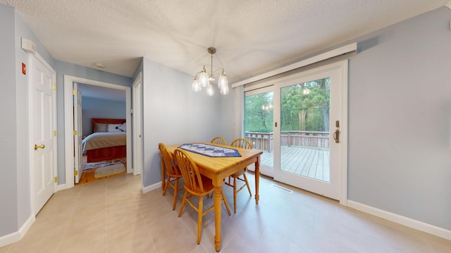14 Daisy Ln, South Yarmouth, MA 02664 - dining area with a chandelier, a textured ceiling, and baseboards