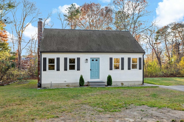 cape cod house with a front yard