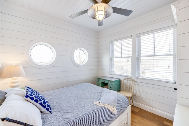 15 W Rd, Eastham, MA 02642 - bedroom featuring wood finished floors, crown molding, wooden walls, and ceiling fan