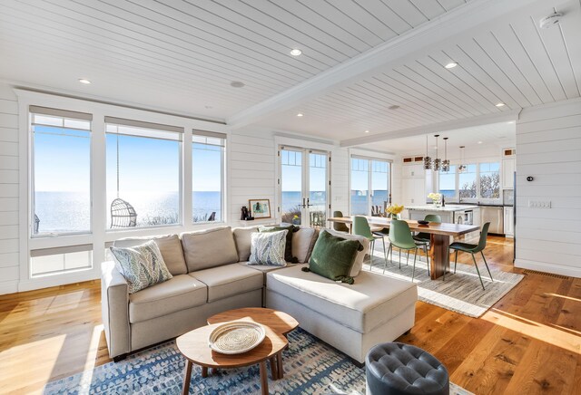 15 W Rd, Eastham, MA 02642 - living area with light wood-style flooring, a chandelier, a water view, and a wood ceiling with exposed beams