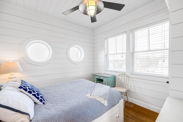 15 W Rd, Eastham, MA 02642 - bedroom featuring wood finished floors, ornamental molding, wooden walls, and ceiling fan