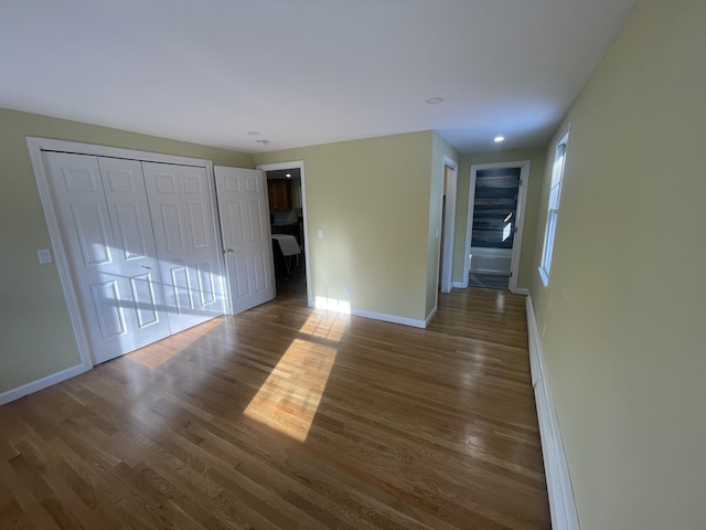 unfurnished living room with dark wood-type flooring