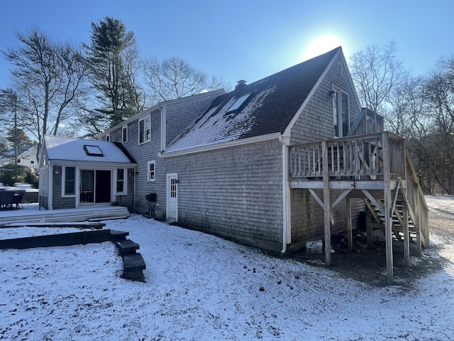 snow covered property featuring a deck