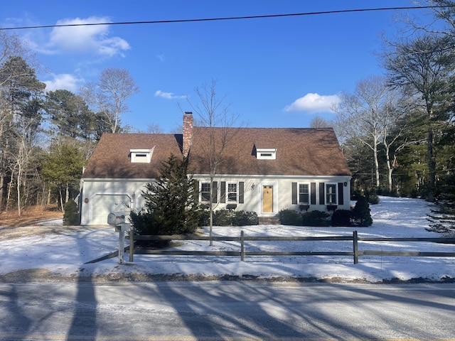 cape cod home with a garage