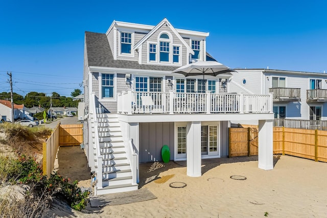 back of property with a deck and a patio