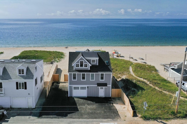 birds eye view of property with a water view and a view of the beach