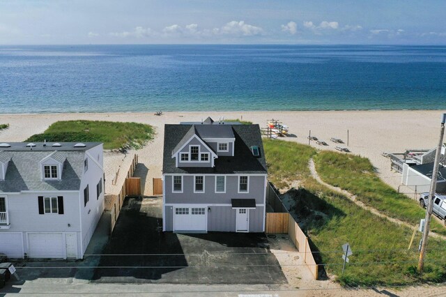 birds eye view of property with a water view and a view of the beach