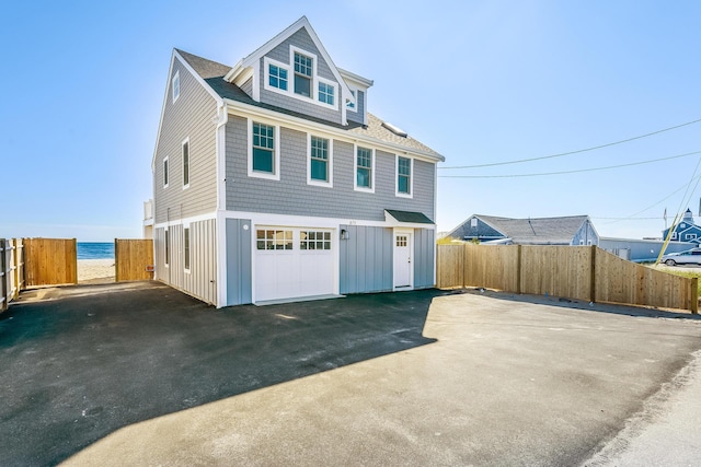 view of front of property featuring a water view and a garage