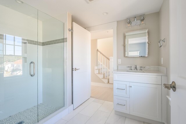 bathroom with vanity, a shower with shower door, and tile patterned flooring