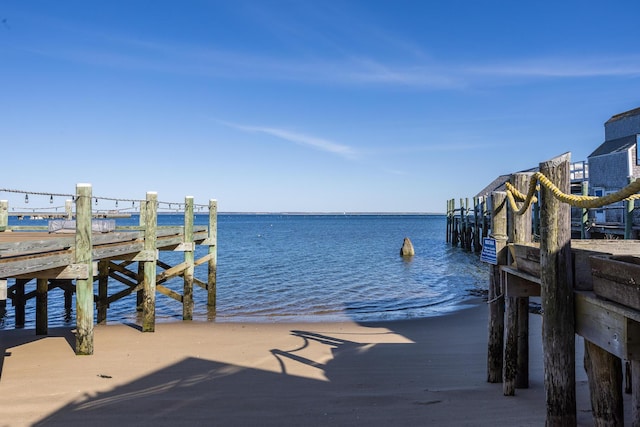 dock area with a water view and a pier