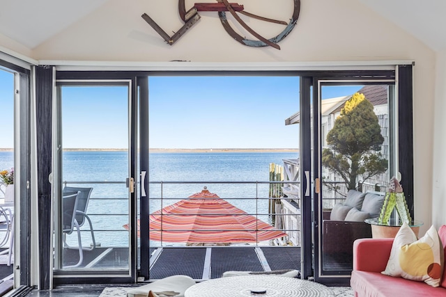sunroom featuring lofted ceiling and a water view