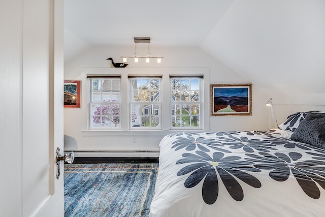 bedroom featuring baseboard heating and lofted ceiling