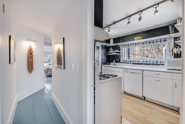 kitchen featuring white appliances, open shelves, light wood-style flooring, and white cabinetry