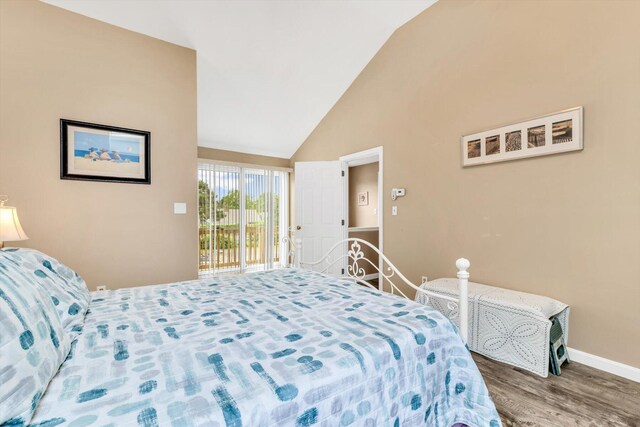 111 School St Unit 6, West Dennis, MA 02670 - bedroom with access to outside, wood finished floors, and high vaulted ceiling