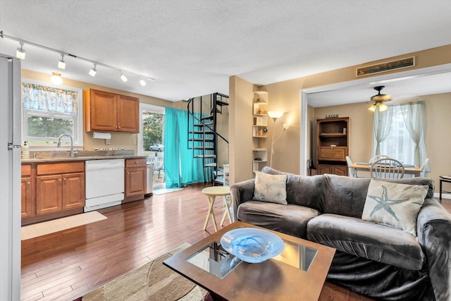 111 School St Unit 6, West Dennis, MA 02670 - living area featuring dark wood-type flooring, a textured ceiling, ceiling fan, and stairway